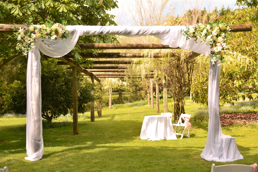 Pergola decoration with artificial flower and organza drape