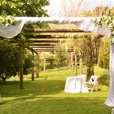 Pergola decoration with artificial flower and organza drape